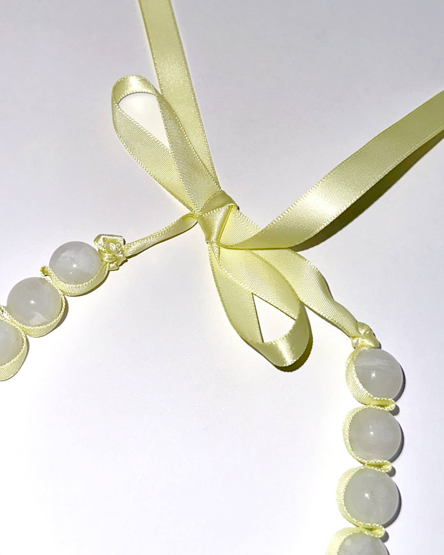 collar lazo amarillo con cuentas grandes blancas